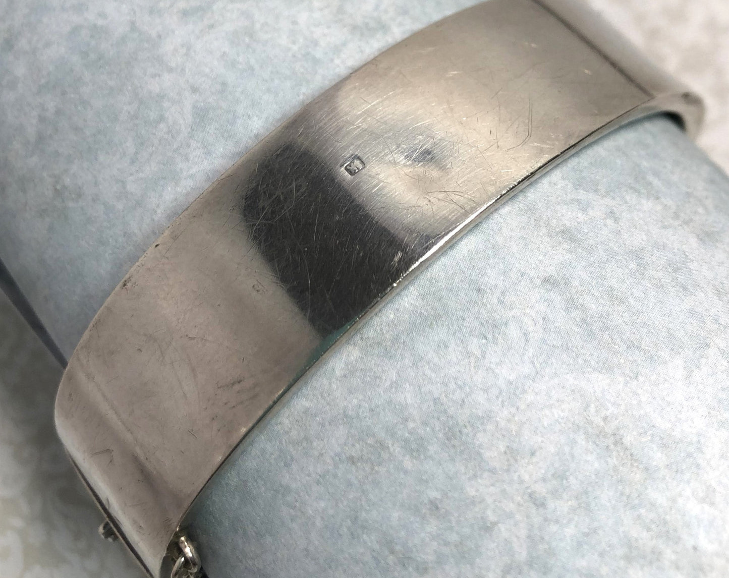 Silver Victorian hinged bangle with hand engraved scroll work. Slight dent on the back.