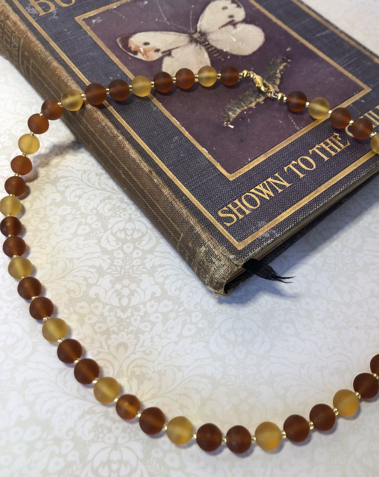 Vintage frosted glass necklace in orange and yellow.