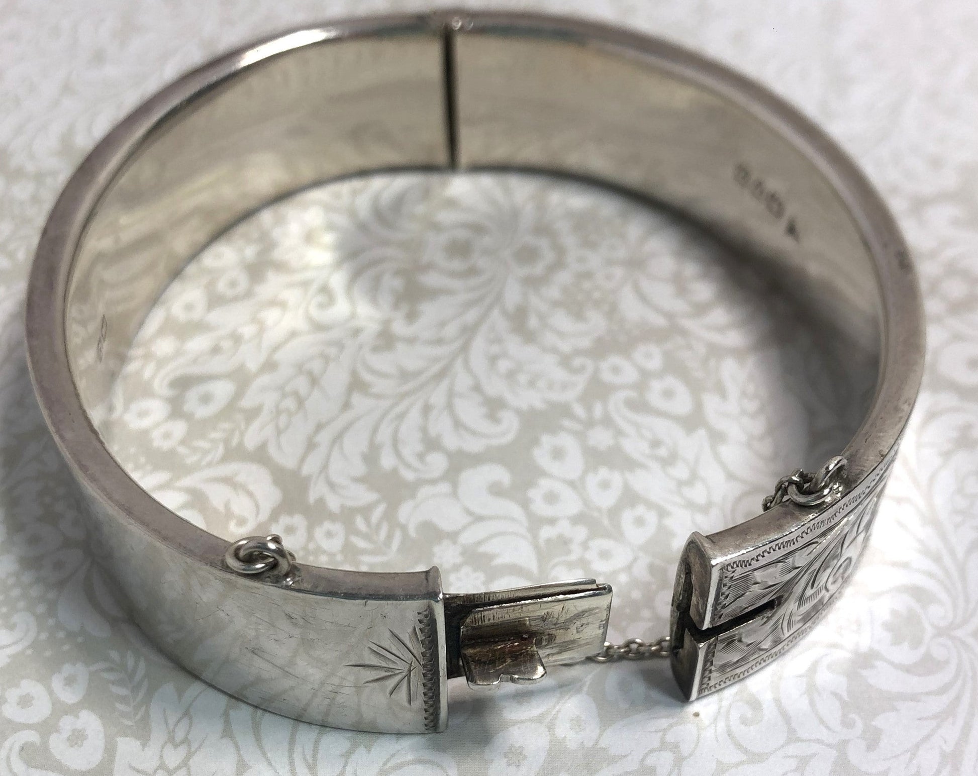 Silver Victorian hinged bangle with hand engraved scroll work